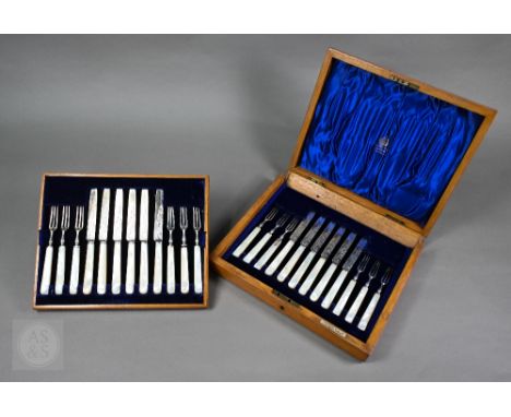 An Edwardian oak cased set of twelve each silver dessert knives and forks with mother of pearl handles, Elkington &amp; Co, B
