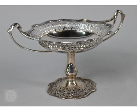 An Asprey silver comport in the Art Nouveau taste, with pierced decoration and whiplash handles, on baluster stem and flared 