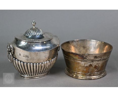 A late Victorian Sheraton Revival silver tea caddy of half-reeded oval form with lion mask and ring handles and hinged cover,