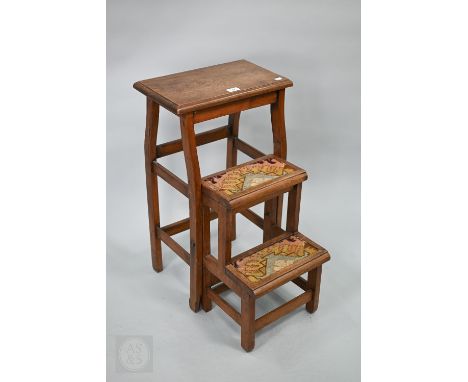 A set of oak Art Nouveau metamorphic library steps, circa 1900, folding into a stool, the two treads with carpet inserts, 40 