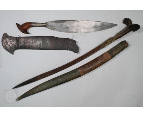 An antique Moro (Southern Philippines) sword Barong with 42cm blade on shaped hardwood hilt with white metal mounts, in carve