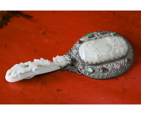 An antique Chinese jade and coloured hardstone mounted silver hand mirror, Qing dynasty, with repoussé decoration worked with