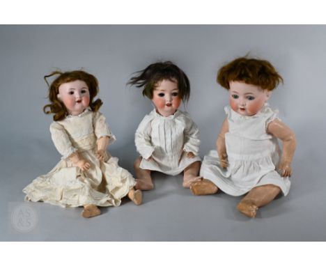 A Heubach-Koppelsdorf 320.2 bisque-headed girl doll with cropped red wig, sleeping blue eyes and open mouth with two teeth, o