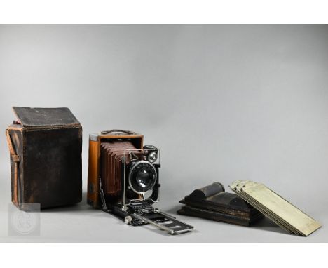 An antique Zeiss Ikon Adoro 230/7 quarter-plate camera with red bellows and Compur Tessar 1:45 f=13,5cm lens, in leather case