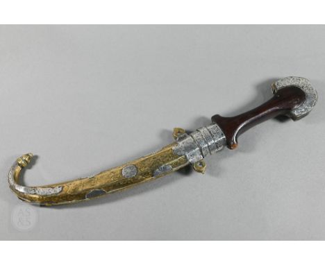 A Moroccan Berber dagger Koummya with double-edged curved blade and shaped wooden handle with silver-overlaid brass mounts, i