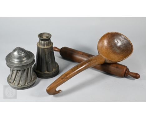 An antique vernacular carved wood ladle with hooked handle, 41 cm to/w a turned yew rolling pin and two pewter jelly-moulds (