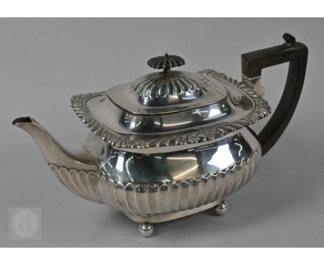 A heavy quality silver half-fluted tea pot with gadroon, shell and scroll rim, composite mounts, on ball feet, William Hutton