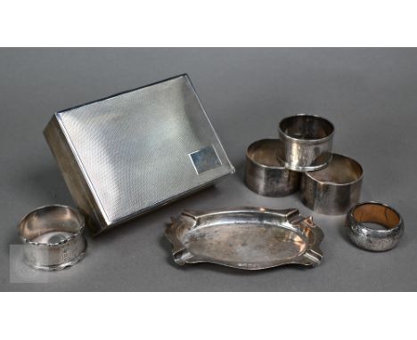 An engine-turned silver cigarette box with cedar lining, Bishton's Ltd, Birmingham 1968, to/w five napkin rings and an ashtra