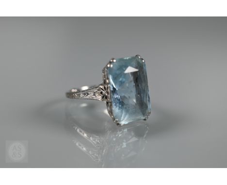 A rectangular baguette-cut aquamarine ring, in white metal millgrain setting, size K, 1.8 x 1.2 cm (with sizing beads)