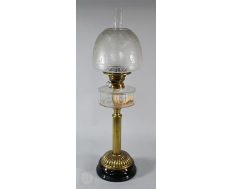 A Victorian brass column oil lamp with finely-etched glass shade and facetted glass font, 70cm high