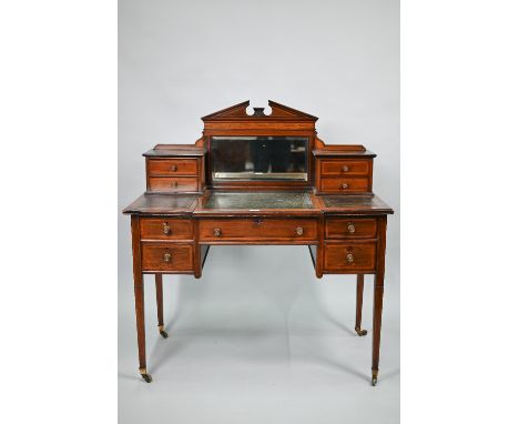 A Victorian boxwood inlaid satinwood breakfront writing/dressing table, the superstructure centred by a mirror flanked by fou