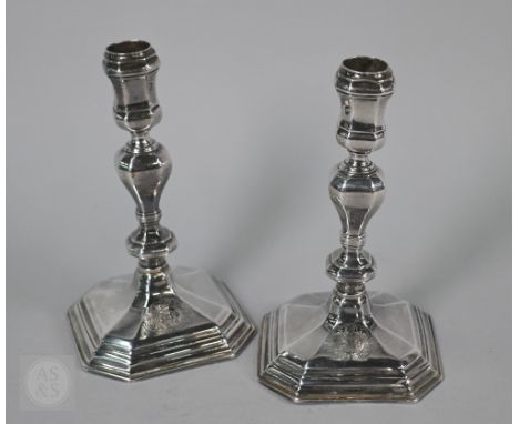 A pair of Queen Anne Britannia standard cast silver candlesticks of octagonal baluster form with stepped bases, Anthony Nelme