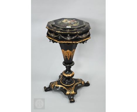 A Victorian gilt and polychrome decorated black lacquer papier mâché teapoy, the hinged top enclosing twin lidded canisters a