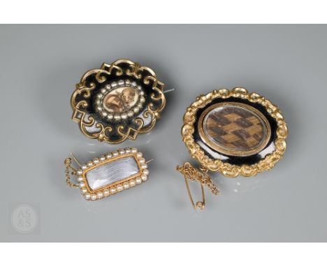 Three Victorian mourning brooches, two with black enamel and hairwork centres, one rectangular with seed pearl border (3)