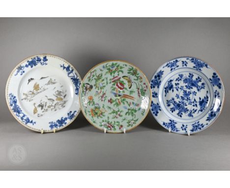 Three antique Chinese plates; two 18th century blue and white examples, one gilded and en-grisaille enamelled with a mountain