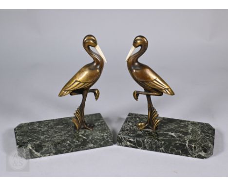 A pair of Art Deco style bronzed storks with bone beaks, stamped Gual, 17 cm high, on marble bases (2)