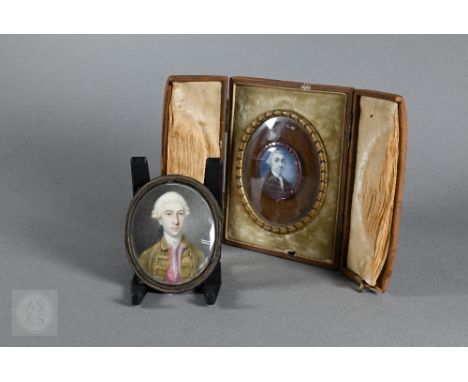 An 18th century oval portrait miniature on ivory of a military officer in powdered wig, his dark brown tunic with gold braid,