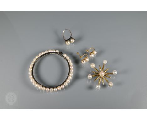 A pearl set brooch in the form of a twelve-point star, with cultured pearl set centre and ends, unmarked yellow metal set, 5 