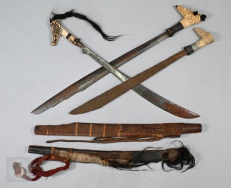 An Antique Borneo Kajan-Dayak sword with 62.5cm shaped and engraved blade on carved bone hilt with wire-bound grip and soft h