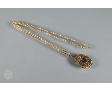 A yellow gold curb link necklace stamped 9ct, 24.5 cm long (closed) with oval engine turned locket attached, approx 11.9g all