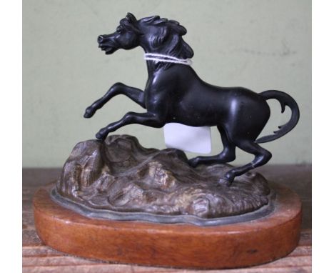 A bronze sculpture of a rearing horse, on oak base, 12cm high