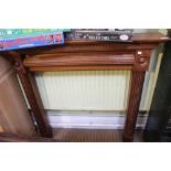 A modern wooden fire surround with reeded column decoration