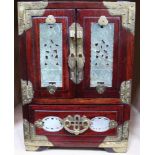 An Oriental jewellery casket, polished wood with brass mounts & pierced hardstone panels, contains a