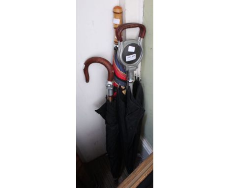 Two shooting stick umbrellas plus another