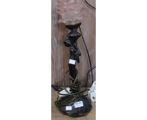 A bronze effect figural table lamp with petal glass shade