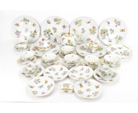 A Herend porcelain 'Queen Victoria' pattern tea service, comprising of a teapot, two lidded pot, milk jug, two oval plates, s