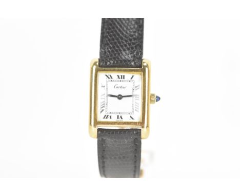 A Cartier Tank , manual wind, ladies, gold plated wristwatch, the rectangular dial having Roman numerals, with a sapphire win