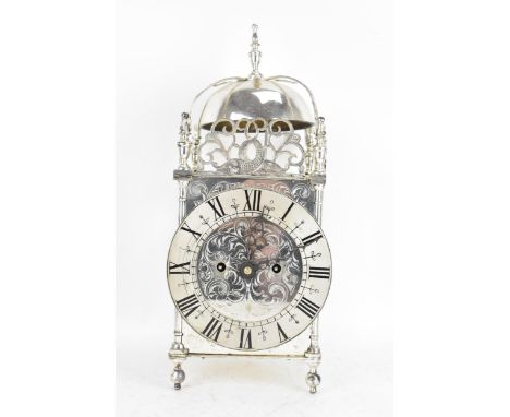 An early 20th century silver plated lantern clock, in the 17th century style having a turned finial, strap work bell with pre