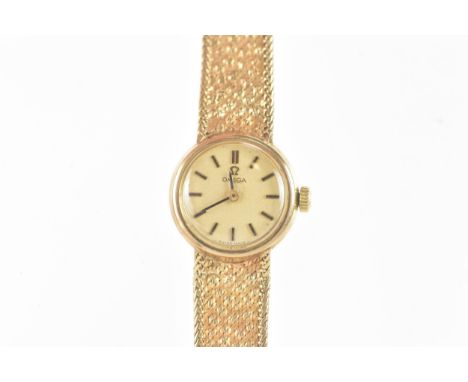 An Omega, manual wind, ladies, 9ct gold wristwatch, circa 1971, the gilt dial having baton markers, with an integral 9ct gold