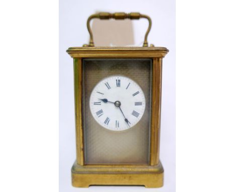 A 20th century brass carriage clock, the engine turned and white enamelled dial with roman numerals, bevelled glass plates, H