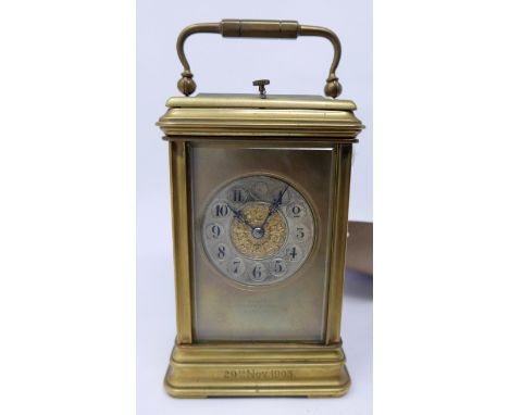 An early 20th century brass carriage clock, with bevelled glass plates, the dial signed T.Elliot and dated 1903, H.18 W.9 D.8