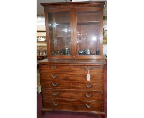 A Regency mahogany secretaire bookcase, two glazed doors enclosing adjustable shelves, the pull out desk with fully fitted ma