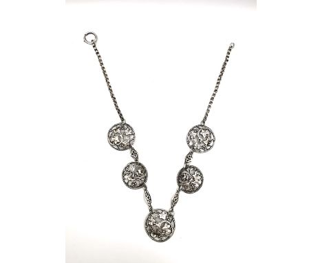 A Victorian silver belcher chain articulated necklace with five silver pierced plaques (converted buttons), three with ivy an