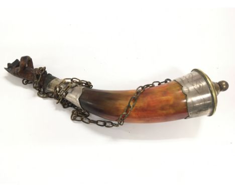 A 19th century horn powder flask with white metal mounts and a carved stopper