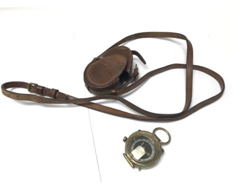 A leather cased military compass.