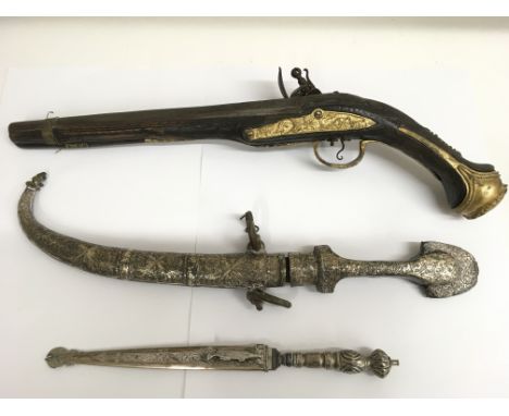 A replica pistol and a middle eastern sword and dagger