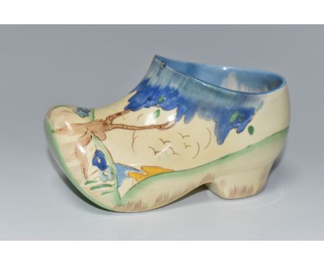 A CLARICE CLIFF SMALL SABOT/CLOG, in Taomina pattern, painted with blue stylised trees in a coastal landscape, dripped glaze 