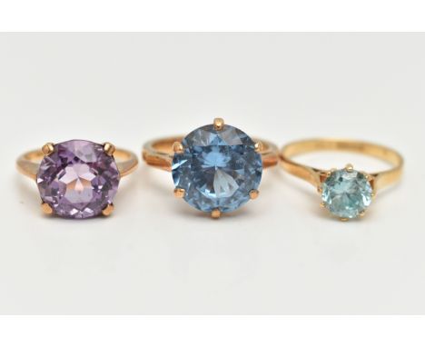 AN 18CT GOLD ZIRCON RING AND TWO GEM SET RINGS, the first set with a circular cut light blue zircon, claw set, pinched should