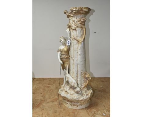 AN EARLY 20TH CENTURY ROYAL DUX FIGURAL VASE, modelled as a tree trunk with classical female figure with dog on a lead, pink 