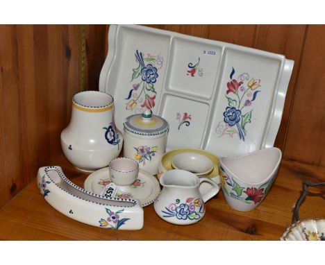 EIGHT PIECES OF POOLE POTTERY, all with floral decoration, including an hors oeuvres dish, an eggcup on integral stand, a pre