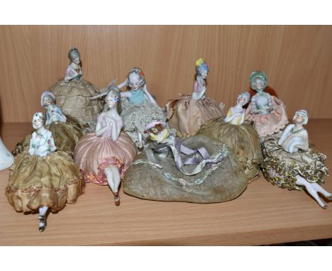 A GROUP OF LATE 19TH AND EARLY 20TH CENTURY PORCELAIN PIN DOLLS, nine pin cushion dolls and one lavender pomander doll, compr