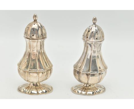 A PAIR OF EDWARDIAN SILVER PEPPERETTES, baluster form, on oval bases with pointed finial covers, each hallmarked 'James Deaki