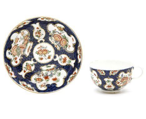 An 18th century Worcester porcelain teacup and saucer, decorated in the 'Rich Kakiemon' pattern, with blue scale ground and f