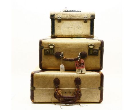 A graduated pair of flying luggage vintage suitcases, with brown leather edging and brass mounts together with skyline vanity