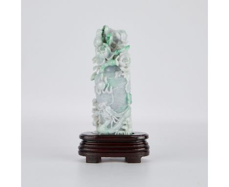Chinese jade carving in the form of a vase, with a dragon carved around the outside in high relief, and flowers clustered aro