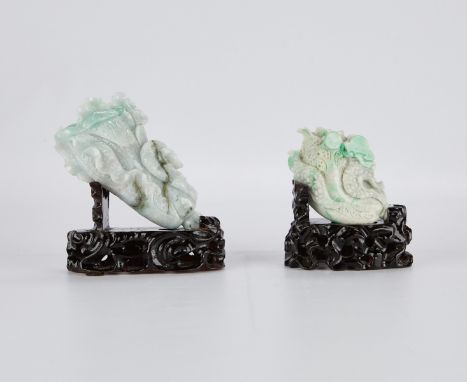 Group of two Chinese jade carvings in the form of cabbages, carved from mottled green and white jade. Both rest on lacquered 